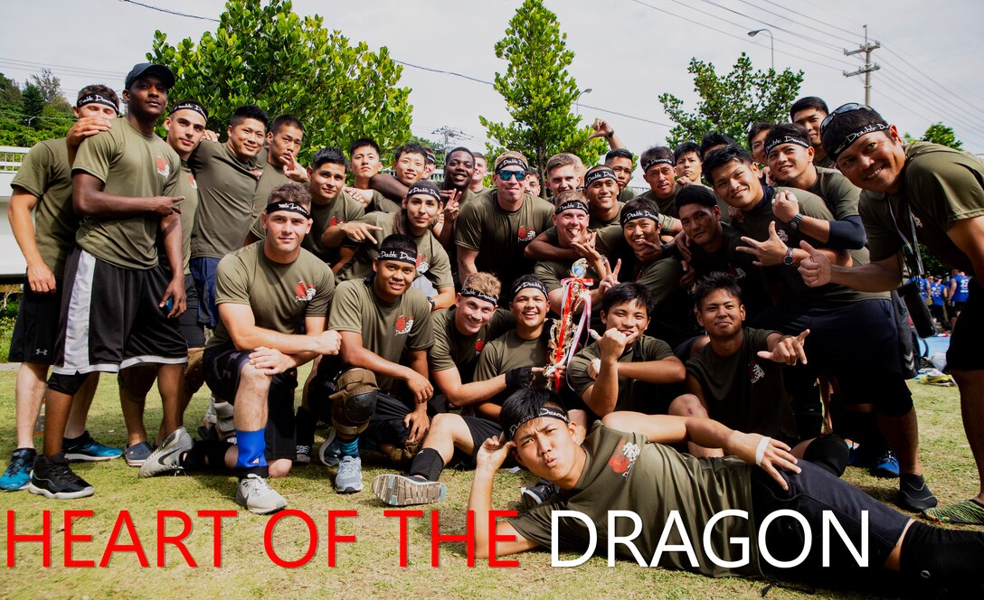 Soldiers with the Japanese Ground Self Defense Force’s 15th Engineer Company and Marines with 9th Engineer Support Battalion, 3rd Marine Logistics Group, smile with their trophy after winning their race May 5, 2018 in Tomari Port, Okinawa, Japan. The combined team, called the Double Dragons, faced Army and Navy dragon boat teams during the annual Naha Hari Dragon Boat races during Okinawa’s Golden Week celebration. (U.S. Marine Corps photo by Cpl. Joshua Pinkney)