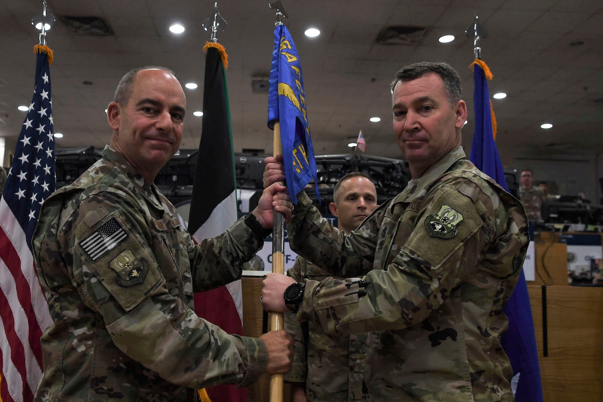 Maj. Gen. Chad Franks (right), 9th Air Expeditionary Task Force - Levant incoming commander, assumes command from Lt. Gen. Jeffrey Harrigian, United States Air Force Central Command commander, during a change of command ceremony May 5, 2018, at an undisclosed location in Southwest Asia.