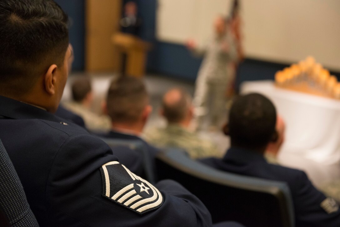 Master Sgt. Rene Allende, a newly promoted senior non-commissioned officer from the 934th Communications Squadron, listens to Col. Tony Polashek, 934th Airlift Wing commander, talk during a promotion recognition ceremony at Minneapolis Air Reserve Station, Minn., May. 5, 2018. The commemoration recognized Airmen who have been promoted to a new tier of the enlisted ranks, signifying a level of accomplishment each inductee has achieved in their Air Force career. (U.S. Air Force Photo by Tech. Sgt. Amber E. N. Jacobs)