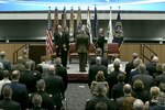 Defense leaders take part in a ceremony.