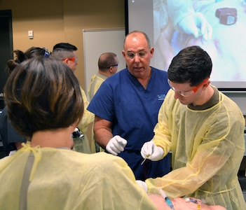 Scotty Bolleter, emergency medical technician, chair of Centre for Emergency Health Sciences, instructs Brooke Army Medical Center Emergency Medicine residents on advanced vascular access techniques and anatomical landmarks as part of EMS Residents Day at the Bulverde Centre for Emergency Health Sciences March 29.