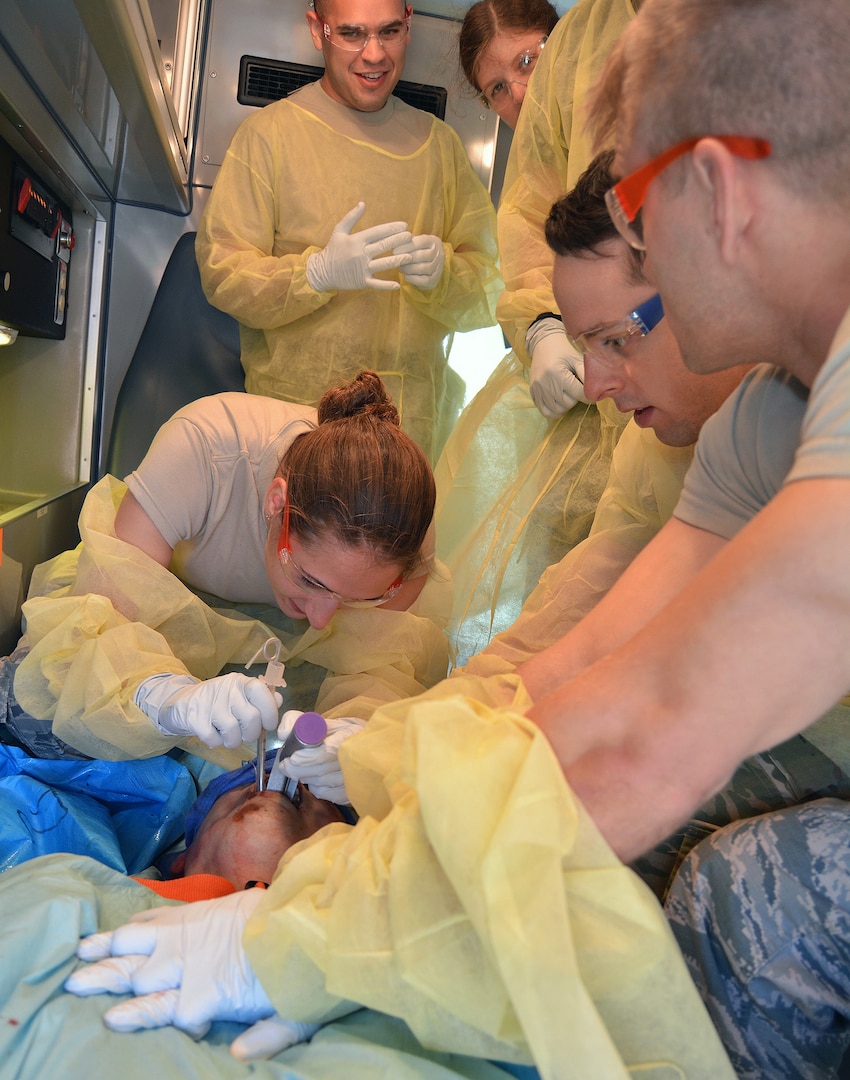 Brooke Army Medical Center Emergency Medicine resident, Air Force Capt. (Dr.) Anna Waller, performs an endotracheal intubation on a cadaver model during an ambulance transport while her colleagues observe and assist at the Bulverde Centre for Emergency Health Sciences as part of EMS Residents Day March 29.