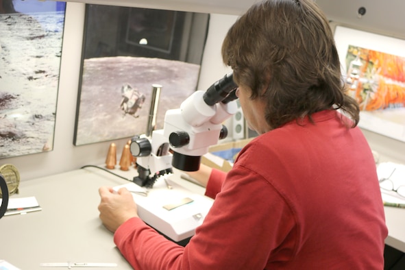 Jefferson Stewart, engineer with Technology Innovations at Arnold Air Force Base, looks through a microscope at one of the parts recently fabricated using additive manufacturing. Stewart and other members of the Technology Innovations Branch have been looking at additive manufacturing, or 3-D printing of metals, as a way to make hardware needed for AEDC operations. (U.S. Air Force Photo/Deidre Ortiz)