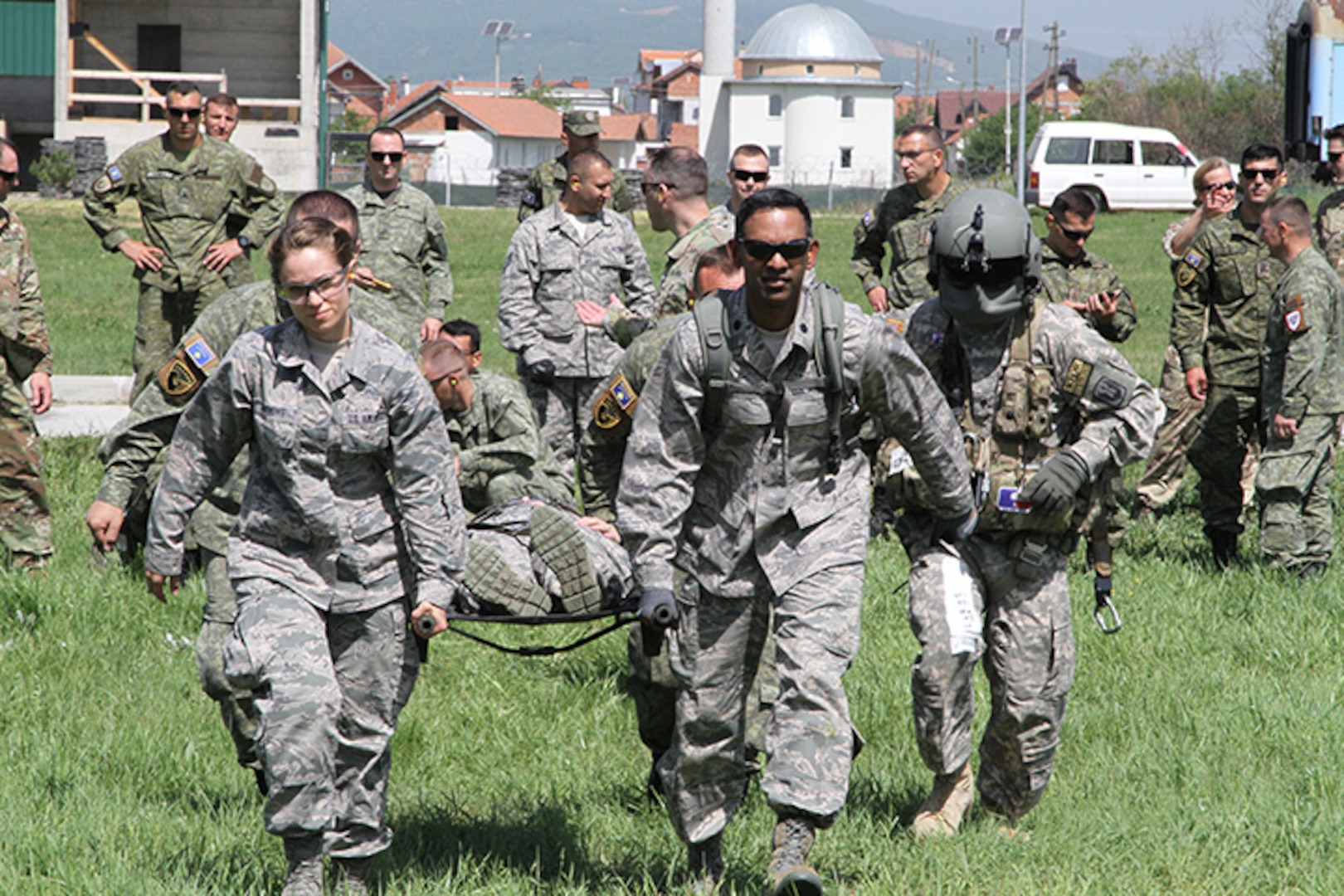 Air National Guard Staff Sgt. Jennifer Simmons 132nd Wing, and Lt. Col. Emile Fernando 185th Air Refueling Wing, both of the Iowa Air National Guard, carry a patient to a helicopter during a medevac training exercise near Pristina, Kosovo, on May 2, 2018. Airmen from the Iowa Guard are in Kosovo participating in a two week exercise held annually as part of the state partner program with Iowa and Kosovo.