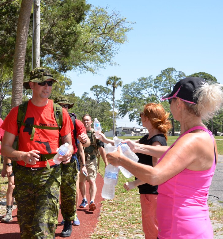 TYNDALL AIR FORCE BASE, Fla.  - Members of the 1st Air Force Key Spouses Club hand out water to participants along the route of the second annual “5K Ruck March for Hunger” May 4 here.
Military and civilian members of 1st Air Force and the 601st Air Operations Center and their family members participated in the event to raise awareness about hunger along with food donations for community food pantries and agencies in the Panama City area.  Nearly 100 people donned 30+ lb. ruck sacks, back packs or donated food to support the food drive which raised 1,911 lbs. The drive began last year when a 1st Air Force Airman saw a statistic stating that numerous students in Bay County were going to school hungry.  (Air Force photo by Mary McHale)