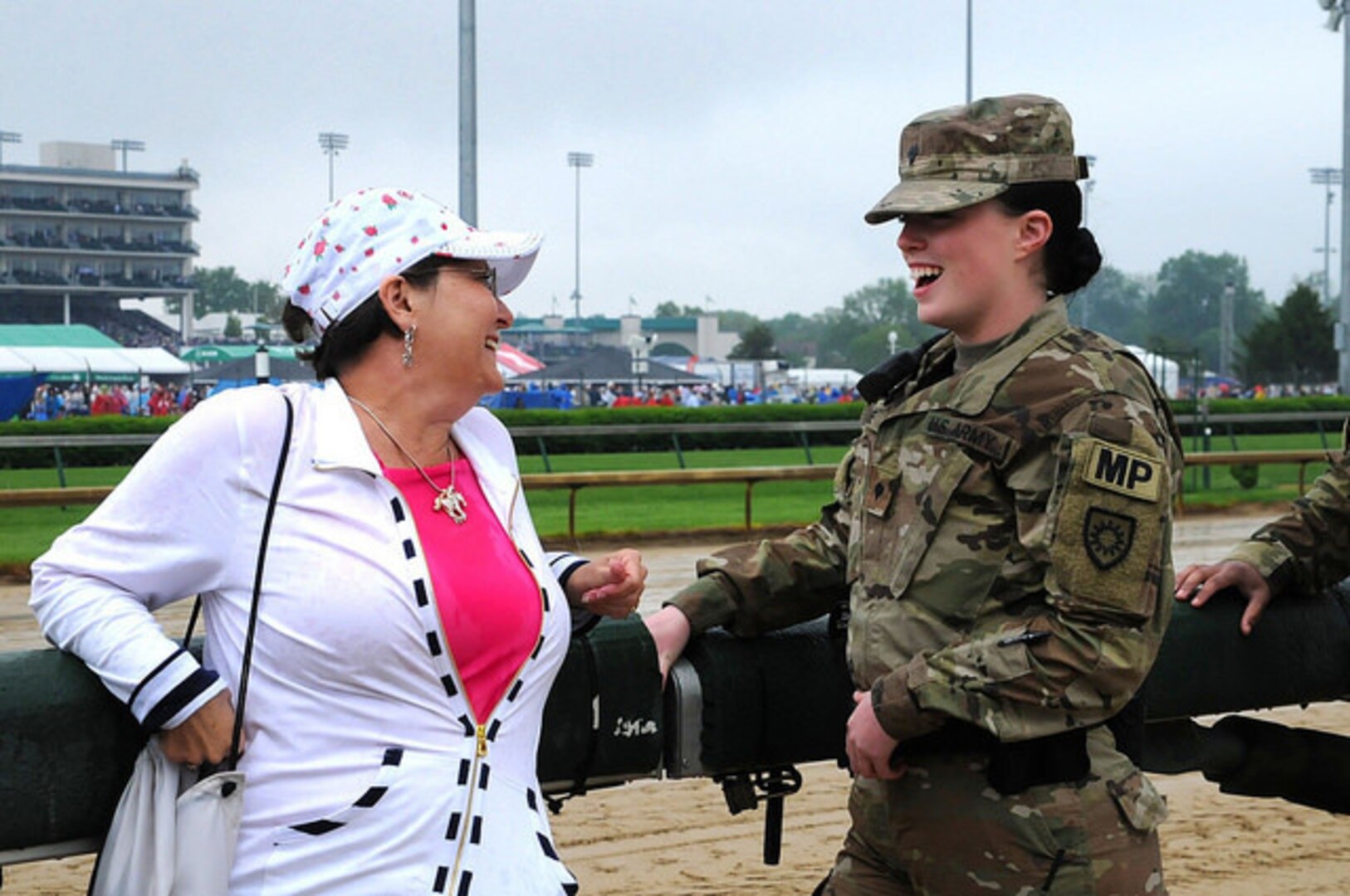 Kentucky Army National Guard member Spc. Mackenzie Kline, 617th MP Company, talks with an attendee at the 144th Kentucky Derby at Churchill Downs May 5, 2018.