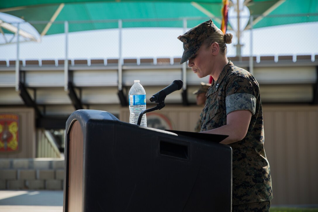 Capt. Karen Holliday, director, Communication Strategy and Operations Office, narrates the retirement ceremony of  Lt. Col. Robert L. Warfield II, director, Marine Corps Community Services, at the flag pole aboard the Marine Corps Air Ground Combat Center, Twentynine Palms, Calif., April 27, 2018. Warfield retired after 27 years of honorable service to the Marine Corps. (U.S Marine Corps photo by Lance Cpl. Margaret Gale)