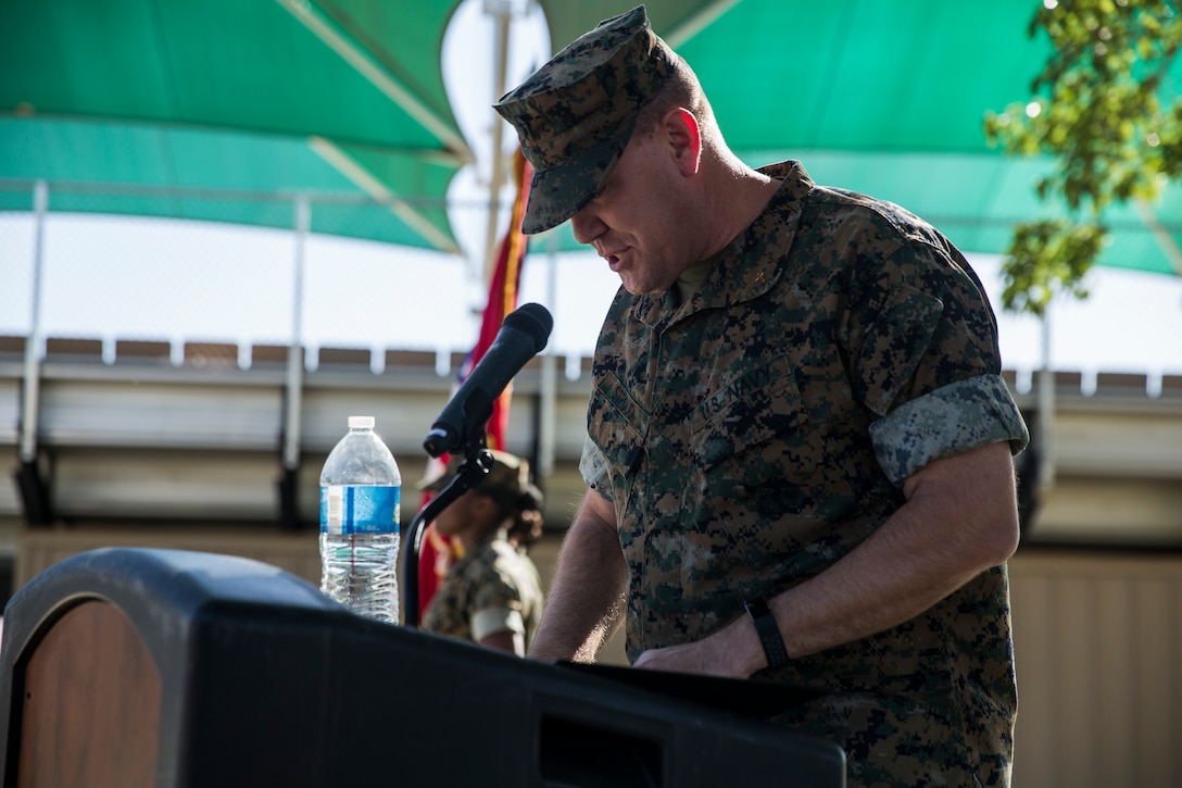 Cmdr. David Stroud, chaplain, Marine Corps Air Ground Combat Center, reads the invocation during the retirement ceremony for Lt. Col. Robert L. Warfield II, director, Marine Corps Community Services, at the flag pole aboard the Marine Corps Air Ground Combat Center, Twentynine Palms, Calif., April 27, 2018. Warfield retired after 27 years of honorable service to the Marine Corps. (U.S Marine Corps photo by Lance Cpl. Margaret Gale)