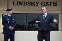 Charles E. Lindsey (right), father of Airman 1st Class Lindsey with Lt. Col. Edge (left), commander of the 902nd Security Forces Squadron, speaks about his late son and expresses gratitude to the 902nd Security Forces Squadron leadership and members at the gate dedication ceremony May 4, 2018.
