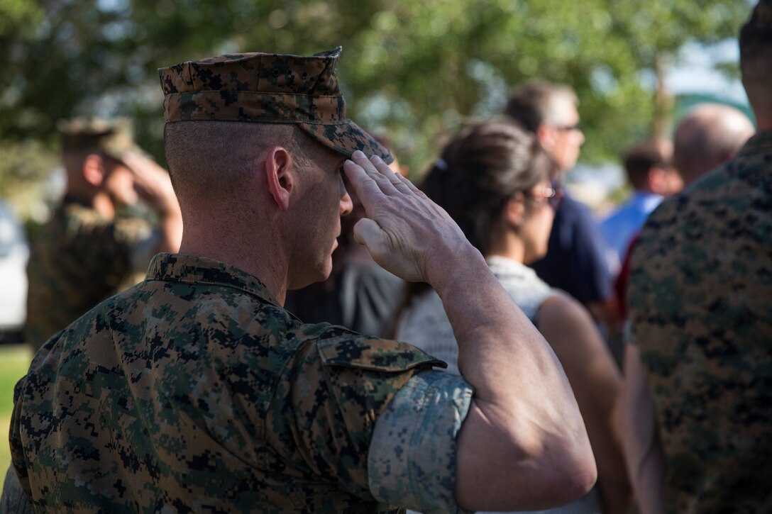 A Marine renders a salute during the playing of the National Anthem during the retirement ceremony for Lt. Col. Robert L. Warfield II, director, Marine Corps Community Services, at the flag pole aboard the Marine Corps Air Ground Combat Center, Twentynine Palms, Calif., April 27, 2018. Warfield retired after 27 years of honorable service to the Marine Corps. (U.S Marine Corps photo by Lance Cpl. Margaret Gale)