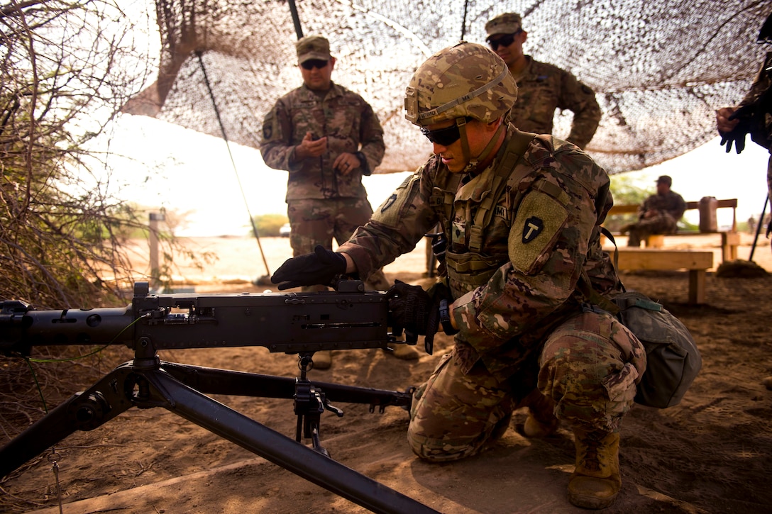 A soldier practices reloading a .50-caliber machine gun.