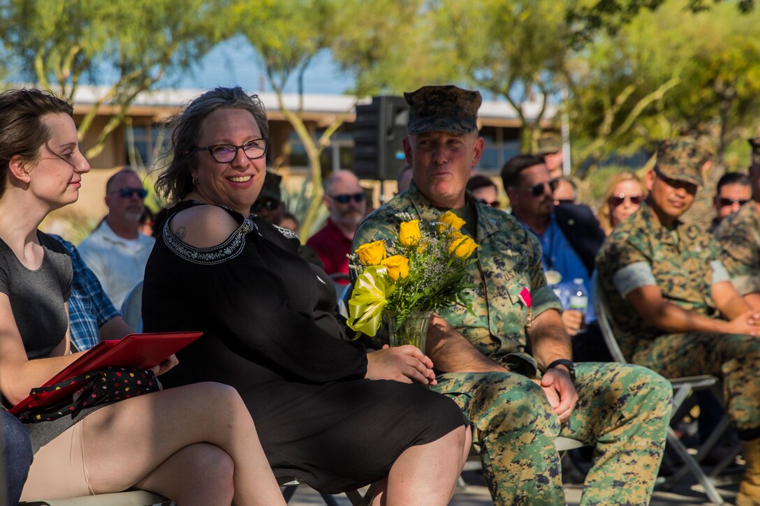 Leah Warfield, wife of Lt. Col. Robert L. Warfield, director, Marine Corps Community Services, is presented with flowers during Warfield’s retirement ceremony at the flag pole aboard the Marine Corps Air Ground Combat Center, Twentynine Palms, Calif., April 27, 2018. Warfield retired after 27 years of honorable service to the Marine Corps. (U.S Marine Corps photo by Lance Cpl. Margaret Gale)