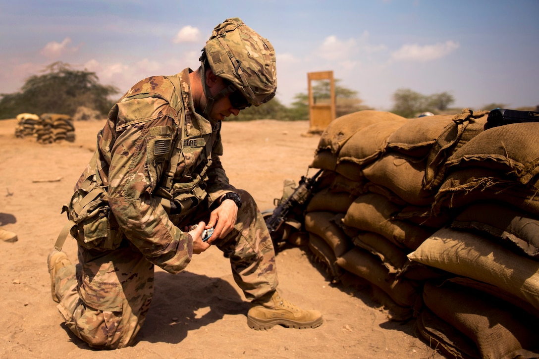 A soldier prepares to throw a practice grenade.
