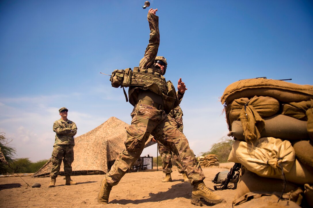 A soldier throws a practice grenade.
