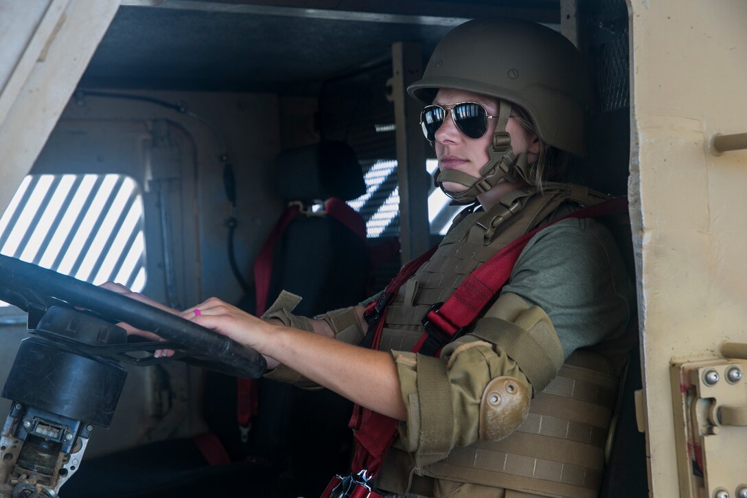 Aimee Coakley, wife of Lance Cpl. Eric Coakley, infantryman, 1st Battalion, 7th Marine Regiment, rides in the drivers seat of a Mine-Resistant Ambush Protected vehicle rollover simulator at Camp Wilson during the unit's Jane Wayne Day aboard the Marine Corps Air Ground Combat Center, Twentynine Palms, Calif., April 27, 2018. This Jane Wayne Day gave the spouses a glimpse into the day-to-day lives of their active duty spouses through the obstacle course, a live-fire range and different battle simulations. (U.S. Marine Corps photo by Lance Cpl. Dave Flores)