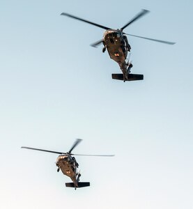 A pair of medical evacuation helicopters prepare to land for a medical corpsman demonstration May 5 at MacArthur Parade Field at Joint Base San Antonio-Fort Sam Houston during the Military Appreciation Weekend celebration.