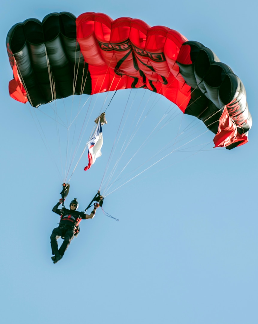 A member of the Black Daggers Parachute Demonstration Team, the U.S. Army's Special Operations Command Parachute Team, comes in for a precision landing while carrying the Texas state flag May 5 at MacArthur Parade Field at Joint Base San Antonio-Fort Sam Houston during the Military Appreciation Weekend celebration.