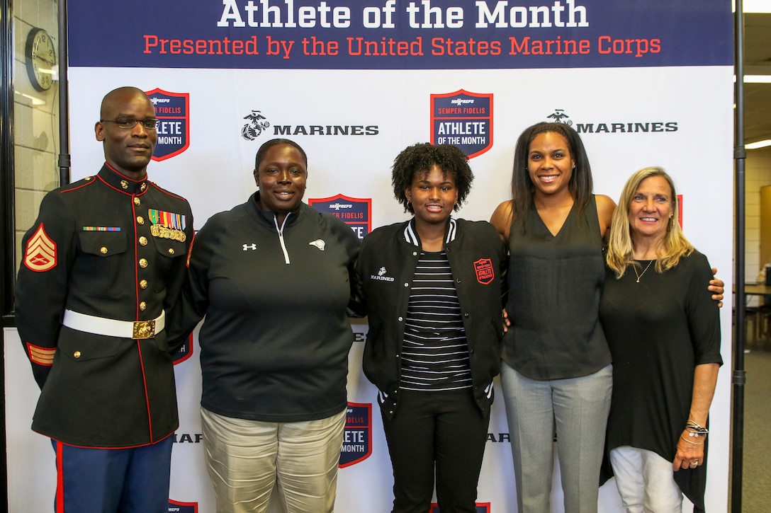 From left: SSgt Adam Harmon, Tameka Wiggins, NyAsia Blango, Lindsay Harding and Anna Spear, pose for a photo after presenting Blango, with the April Female MaxPreps High School Athlete of the Month at Havelock High School in Havelock, North Carolina, May 3, 2018. NyAsia is the school’s top performer on the basketball court, is ranked 16th in North Carolina and 510th in the nation for high school women’s basketball. Additionally, she maintains a 3.78 GPA and loves giving back to her hometown. This past winter, she collected 180 pairs of new or gently-used shoes and hand-delivered them to three shelters in her area. Harmon is the Marine Corps Recruiter for the school, Wiggins is the coach for the women’s basketball team, Harding is the basketball operations associate for the NBA and Spear is the head coach for the women’s basketball team. (U.S. Marine Corps photo by Sgt. Antonio J. Rubio/Released)