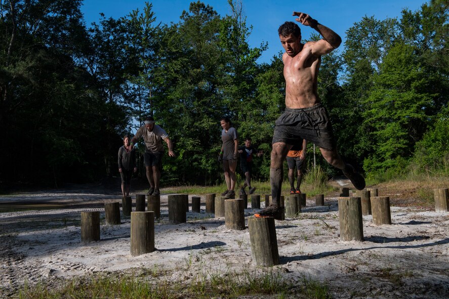 Moody Mud Run participants hop through an obstacle, May 5, 2018, in Ray City, Ga. Participants trekked 4.6 miles through the mud, water and 29 obstacles that made up the course. This is the fifth year Moody has hosted the event and more than 800 patrons participated. (U.S. Air Force photo by Senior Airman Janiqua P. Robinson)