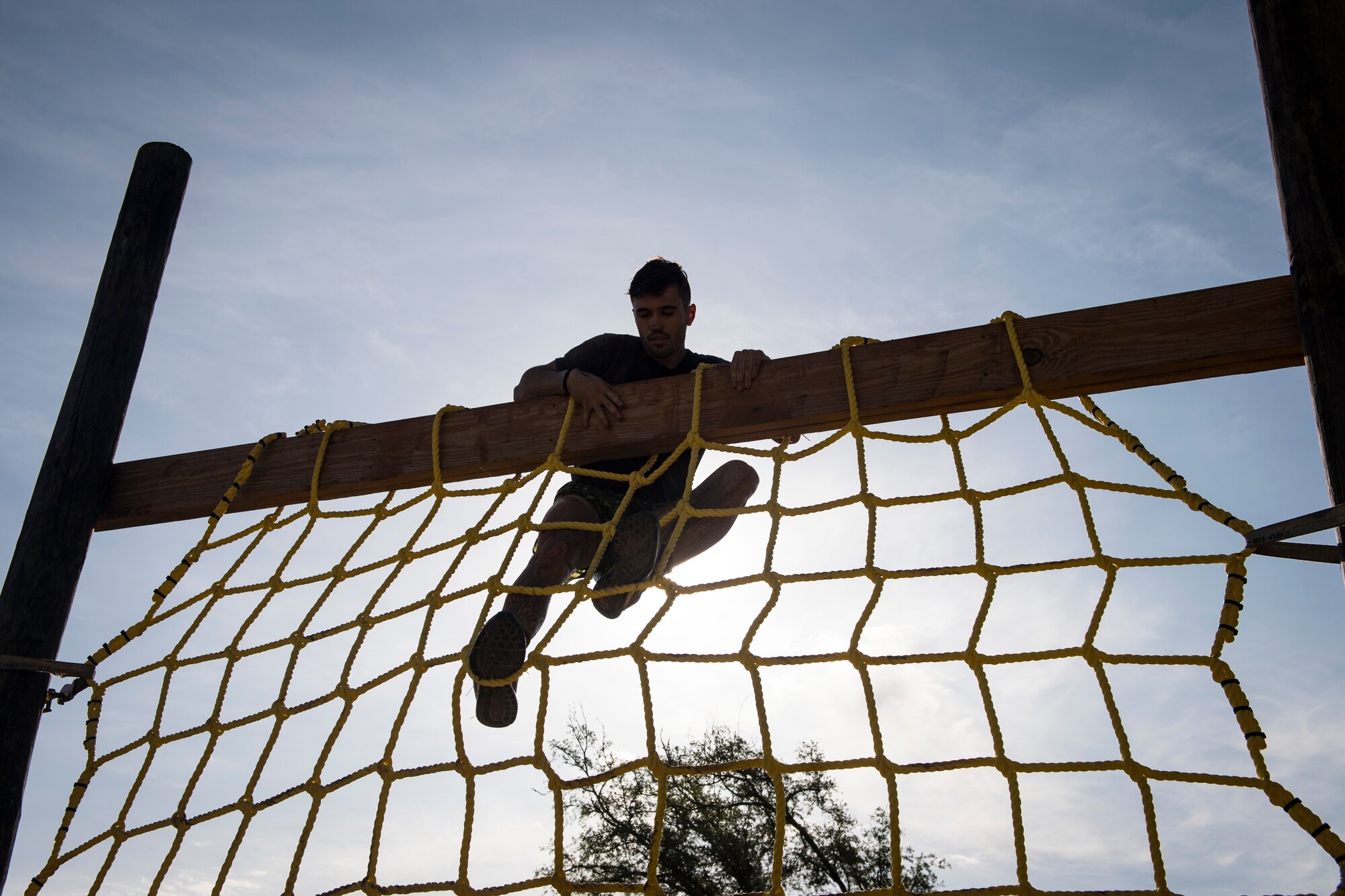 A Moody Mud Run participant climbs a rope obstacle, May 5, 2018, in Ray City, Ga. Participants trekked 4.6 miles through the mud, water and 29 obstacles that made up the course. This is the fifth year Moody has hosted the event and more than 800 patrons participated. (U.S. Air Force photo by Senior Airman Janiqua P. Robinson)