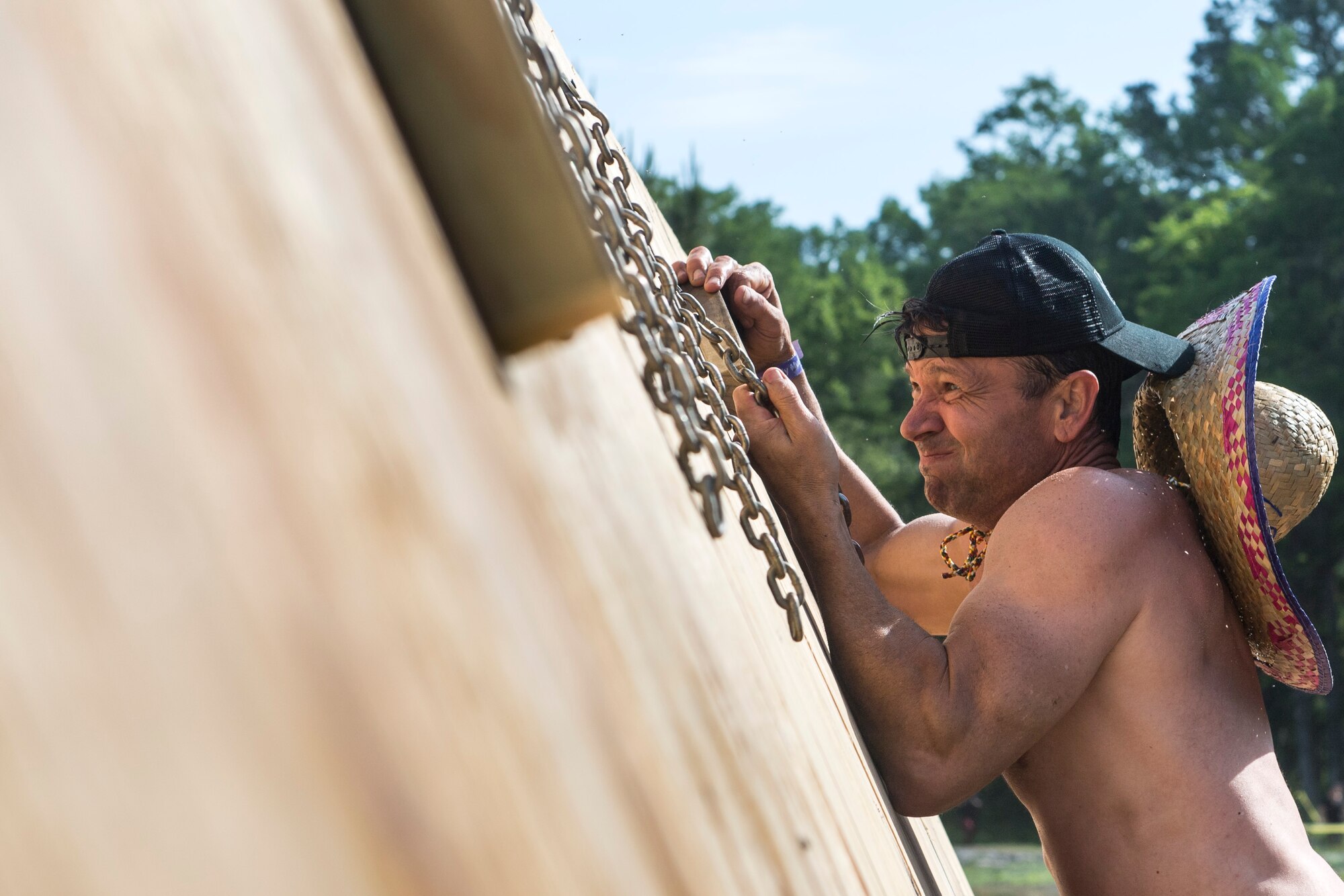 A Moody Mud Run participant attempts an obstacle, May 5, 2018, in Ray City, Ga. Participants trekked 4.6 miles through the mud, water and 29 obstacles that made up the course. This is the fifth year Moody has hosted the event and more than 800 patrons participated. (U.S. Air Force photo by Senior Airman Janiqua P. Robinson)