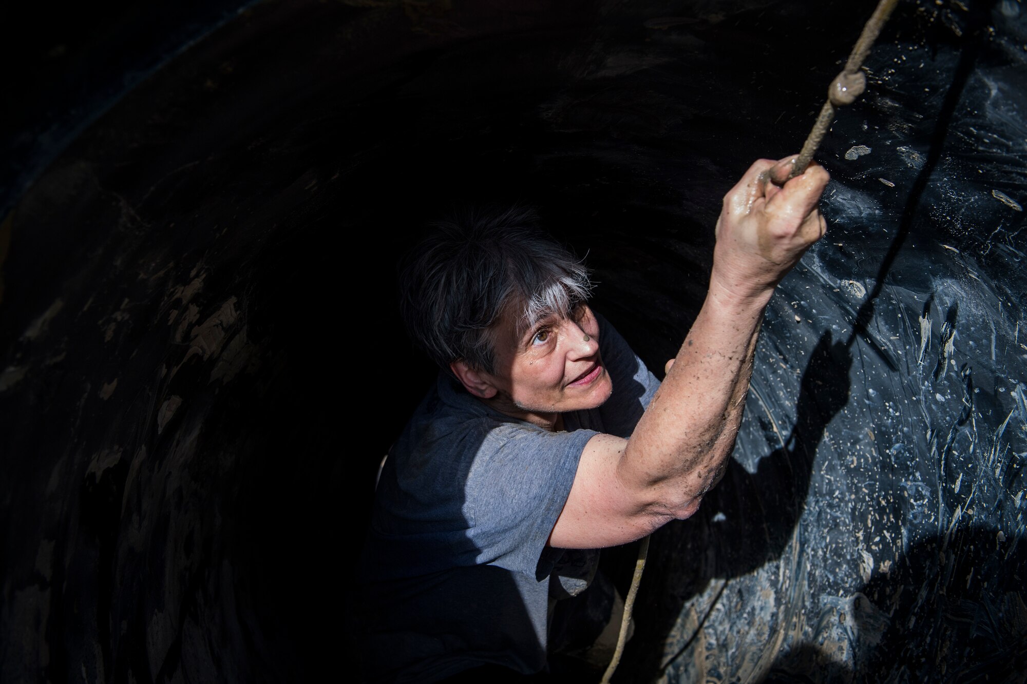 A Moody Mud Run participant reaches the peak of an obstacle, May 5, 2018, in Ray City, Ga. Participants trekked 4.6 miles through the mud, water and 29 obstacles that made up the course. This is the fifth year Moody has hosted the event and more than 800 patrons participated. (U.S. Air Force photo by Senior Airman Janiqua P. Robinson)