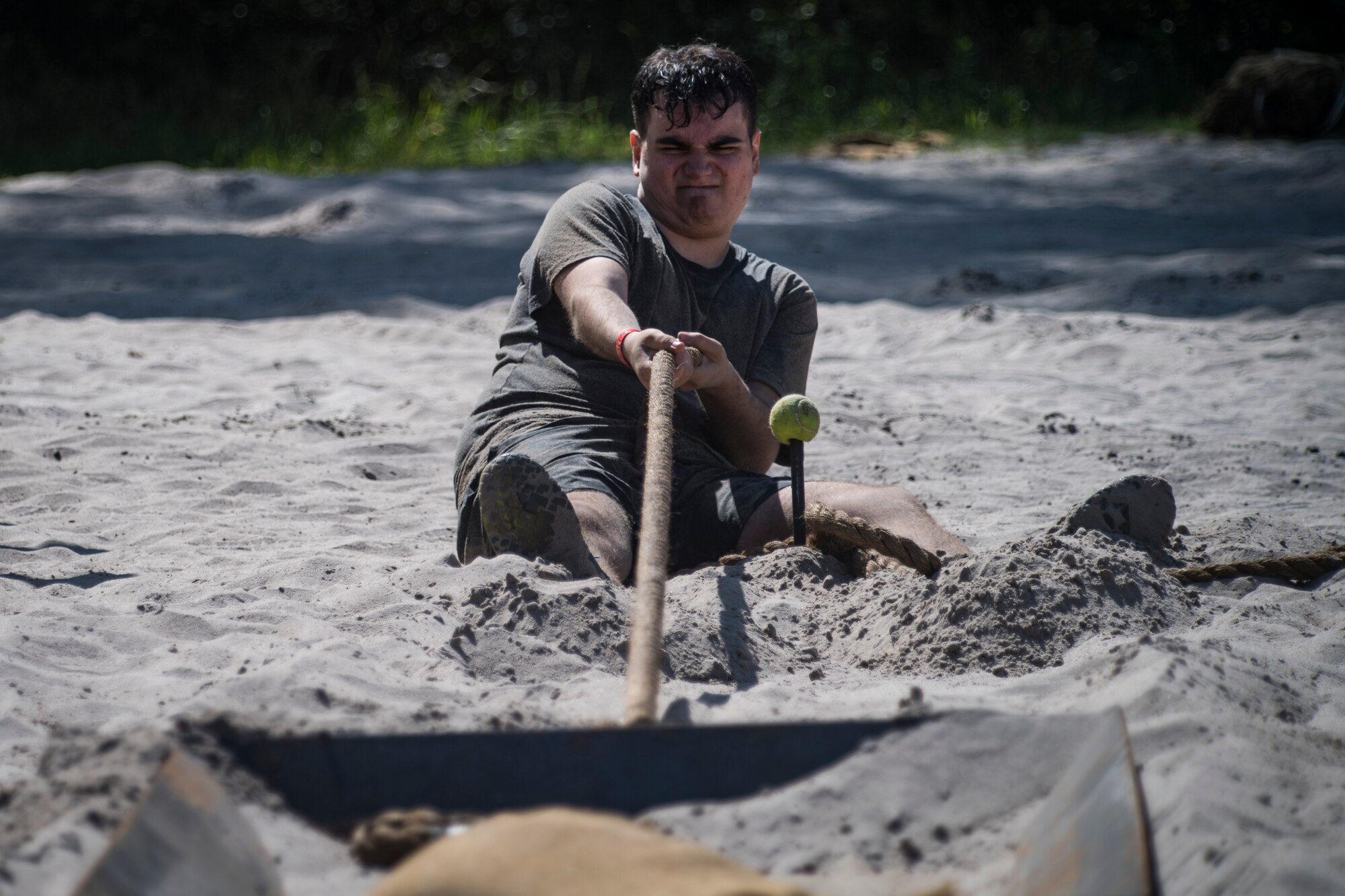 A Moody Mud Run participant attempts an obstacle, May 5, 2018, in Ray City, Ga. Participants trekked 4.6 miles through the mud, water and 29 obstacles that made up the course. This is the fifth year Moody has hosted the event and more than 800 patrons participated. (U.S. Air Force photo by Senior Airman Janiqua P. Robinson)