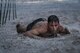 A Moody Mud Run participant crawls under barbed wire, May 5, 2018, in Ray City, Ga. Participants trekked 4.6 miles through the mud, water and 29 obstacles that made up the course. This is the fifth year Moody has hosted the event and more than 800 patrons participated. (U.S. Air Force photo by Senior Airman Janiqua P. Robinson)