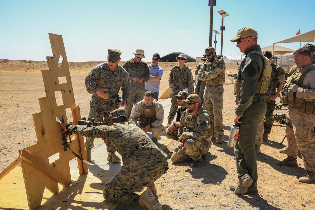 Chief Warrant Officer 3 Michael Skinta, gunner, Marksmanship Training Unit, coaches  participants of a sniper training course hosted by the Marksmanship Training Unit  aboard the Marine Corps Air Ground Combat Center, Twentynine Palms, Calif., April 25, 2018. The sniper course was held from April 24 to April 27, 2018 to advance participants’ skills in marksmanship techniques for combat scenarios. (U.S. Marine Corps photo by Lance Cpl. Isaac Cantrell)
