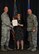 Savannah Hewett, 377th Security Forces Group Key Spouse, is presented with her award for Volunteer of the Year 2017 at the Volunteer Recognition Ceremony April 20 at the Mountain View Club as 377th Air Base Wing Commander Col. Richard Gibbs (left) and Command Chief Master Sgt. Chad Schulte (right) congratulate her.
