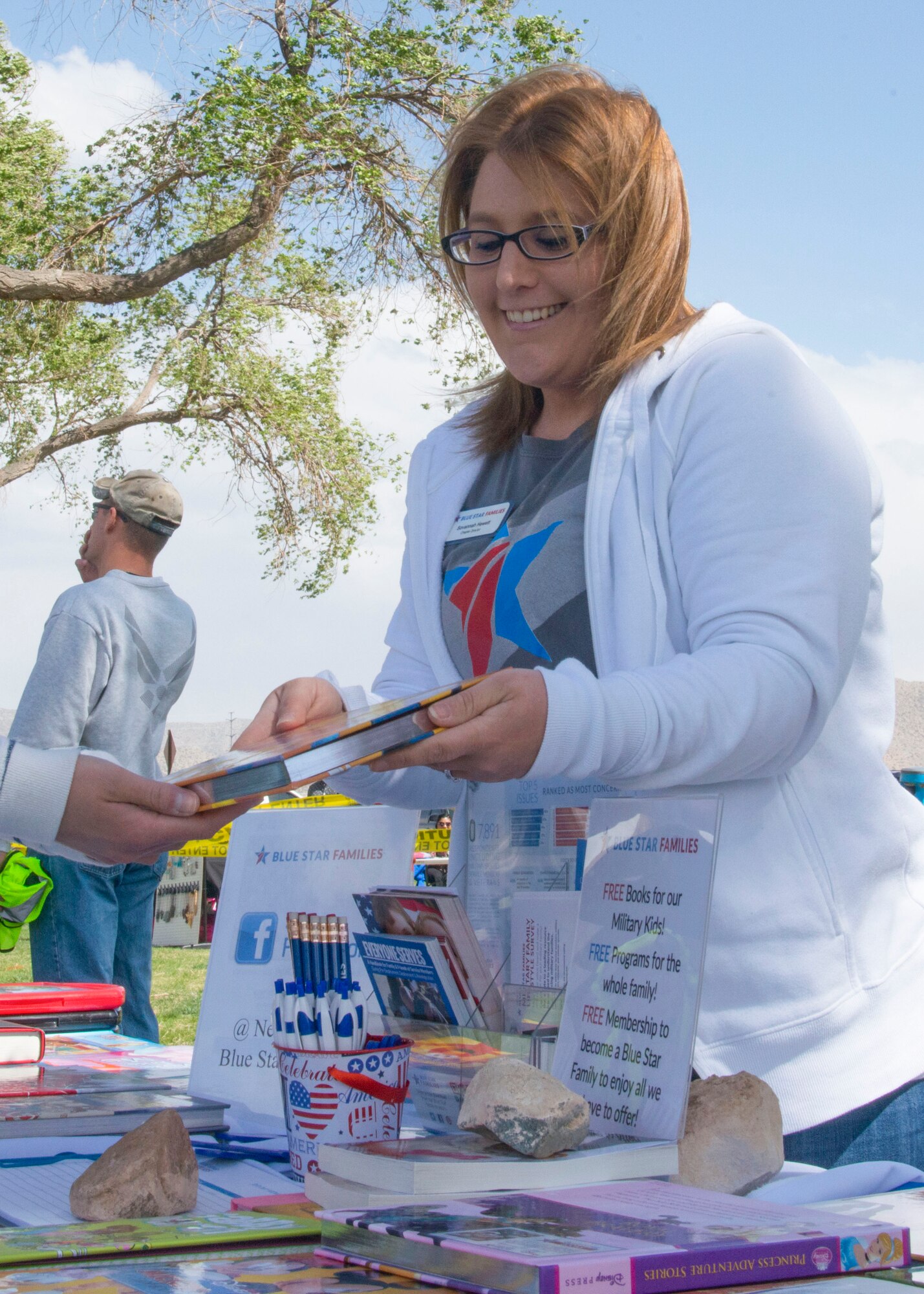 Blue Star Families Chapter Leader Savannah Hewett shares children’s books during set-up at Kirtland Rockfest May 2 at the Mountain View Club. Hewett, also the 377th Security Forces Group Key Spouse, was recently recognized as the 2017 Team Kirtland Volunteer of the Year.