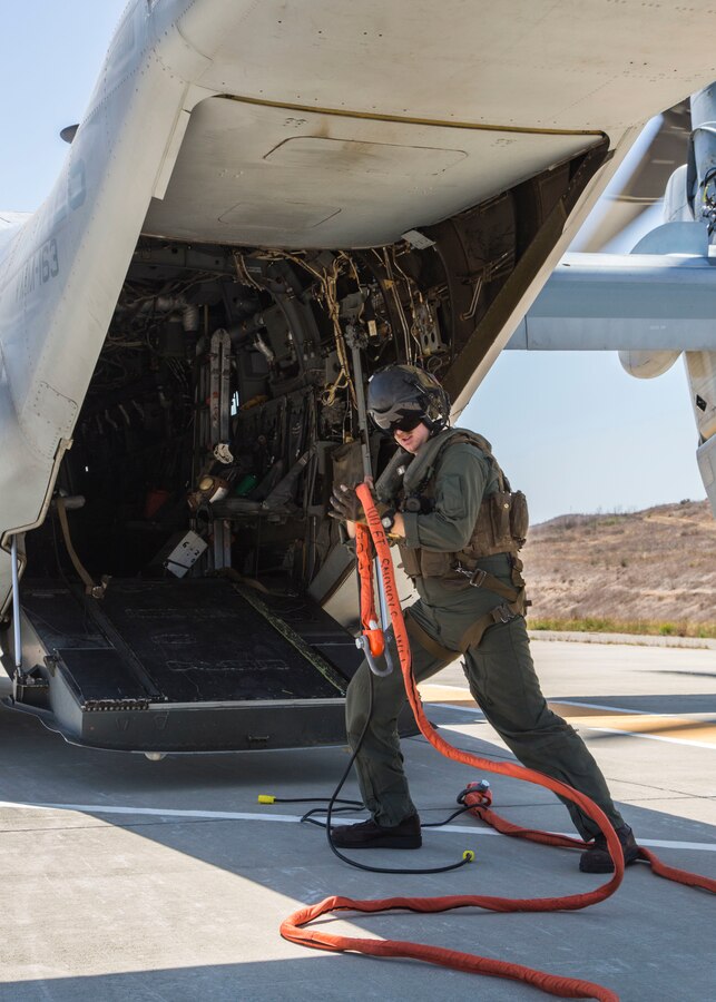 Cpl. Kyle Barger, an MV-22 Osprey crew chief with Marine Medium Tiltrotor Squadron (VMM) 161, Marine Aircraft Group 16, 3rd Marine Aircraft Wing, detangles the firefighting bucket attachment cord during the 2018 Wild Land Firefighting Exercise (WLFFEX) at Marine Corps Base Camp Pendleton, San Diego Calif., May 3. The WLFFEX is an annual training event designed to increase emergency preparedness and military firefighting agencies during California’s wildfire season.  (U.S. Marine Corps Photo by Lance Cpl. Nadia J. Stark/Released)