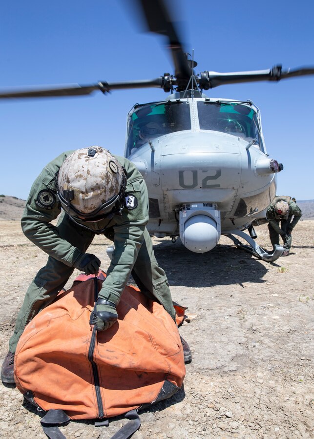 Staff Sgt. Wilton Garcia, right, and Sgt. Seth Garcia, left, crew chiefs with Marine Light Attack Squadron (HMLA) 267, Marine Aircraft Group 39, 3rd Marine Aircraft Wing, pack up a firefighting bucket after completion of the Corey Iverson Wildland Firefighting Exercise at Marine Corps Base Camp Pendleton, Calif., May 3. The exercise is an annual training event designed to increase emergency preparedness and cohesion between civilian and military firefighting agencies during California’s wildfire season. (U.S. Marine Corps photo by Lance Cpl. Clare J. McIntire/Released)