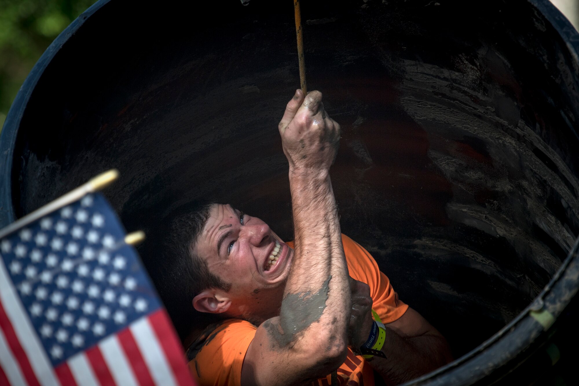 A Moody Mud Run participant pulls himself through a tube obstacle, May 5, 2018, in Ray City, Ga. Competitors trekked 4.6 miles through the mud, water and 29 obstacles that made up the course. This is the fifth year Moody has hosted the event and more than 800 patrons participated. (U.S. Air Force photo by Staff Sgt. Ryan Callaghan)