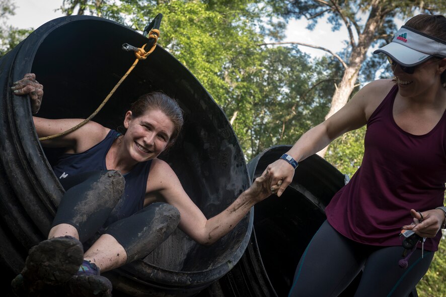 Moody Mud Run participants complete a tube obstacle, May 5, 2018, in Ray City, Ga. Competitors trekked 4.6 miles through the mud, water and 29 obstacles that made up the course. This is the fifth year Moody has hosted the event and more than 800 patrons participated. (U.S. Air Force photo by Staff Sgt. Ryan Callaghan)