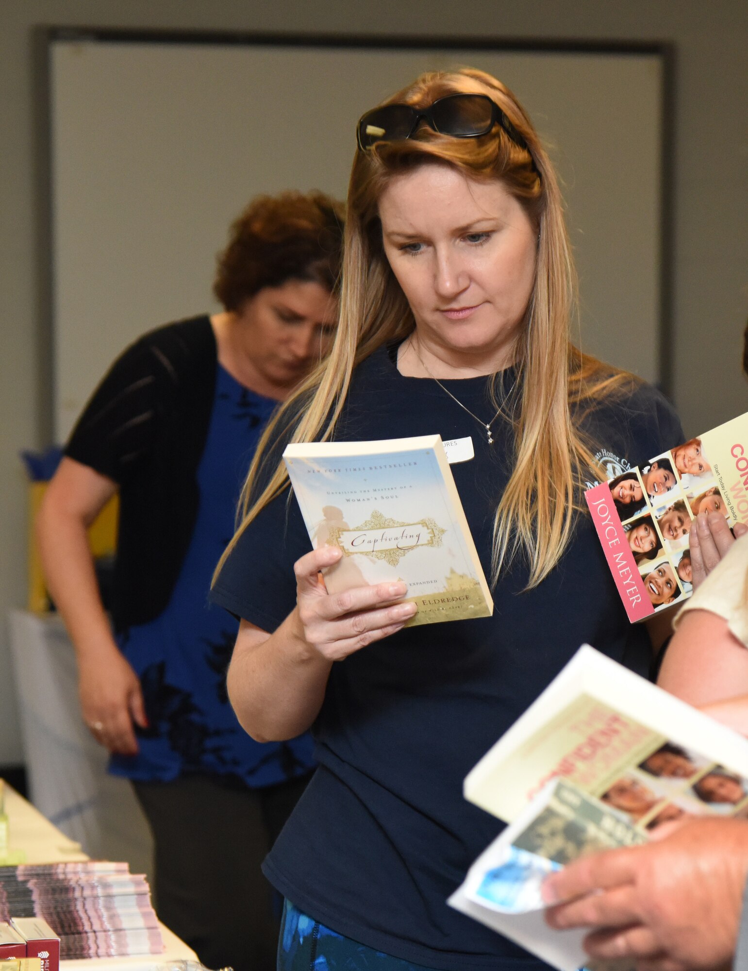 Amanda Sexton, spouse of U.S. Navy Boatswain’s Mate 3rd Class Shane Sexton, Coast Guard Station, Gulfport, Mississippi, looks at books during Pamper Me Day in the Sablich Center at Keesler Air Force Base, Mississippi, May 3, 2018. The 81st Force Support Squadron Airman & Family Readiness Center has hosted the event for the past 14 years, offering military spouses information and business booths, free manicures, makeup tips and giveaways. (U.S. Air Force photo by Kemberly Groue)