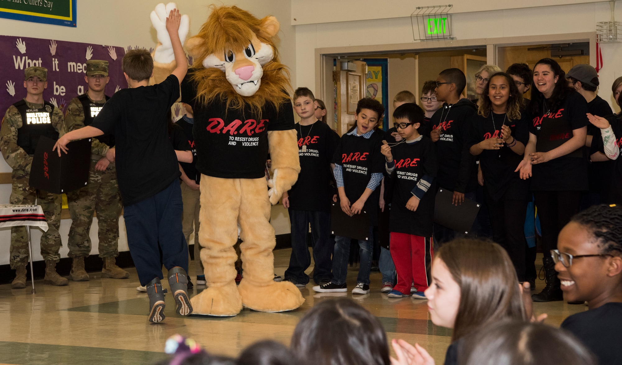 A student from the Drug Abuse Resistance Education program high-fives Daren the Lion at Ursa Major Elementary School at Joint Base Elmendorf-Richardson, Alaska, May 2, 2018. D.A.R.E. is a program designed to provide students with the knowledge and tools they need to resist drugs, alcohol and other high-risk behaviors.
