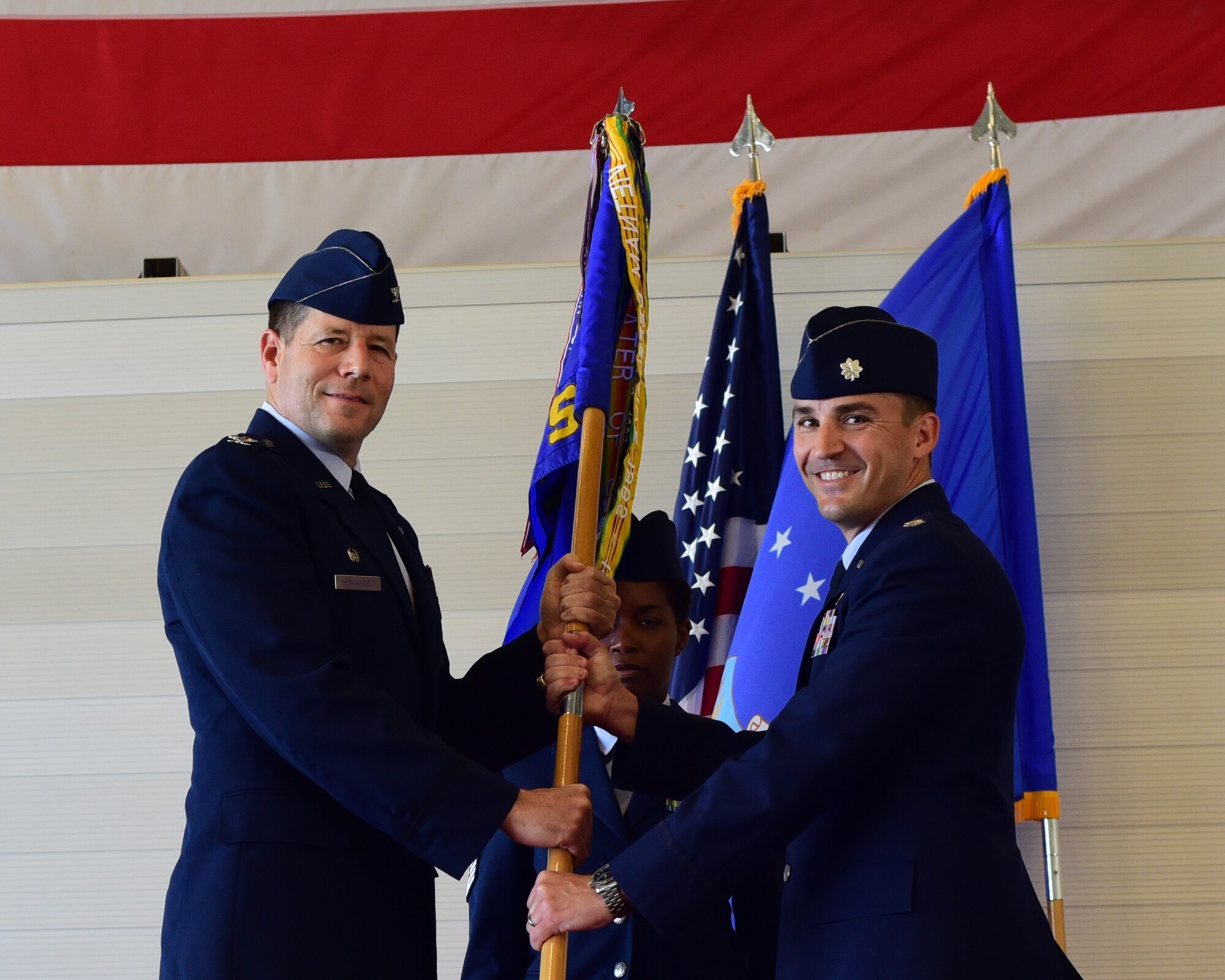 U.S. Air Force Col. Michael Hernandez, 325th Fighter Wing commander, hands the guidon to Lt. Col. Ryan Wick, 43rd Fighter Squadron commander, during a change-of-command ceremony at Tyndall Air Force Base, May 5, 2018. Wick took command of the 43rd FS after Lt. Col. Daniel Arkema. The 43rd FS is one of the oldest active fighter squadrons in the United States and has the mission of training the Air Force’s F-22 fighter pilots. (U.S. Air Force photo by Senior Airman Cody R. Miller /Released)