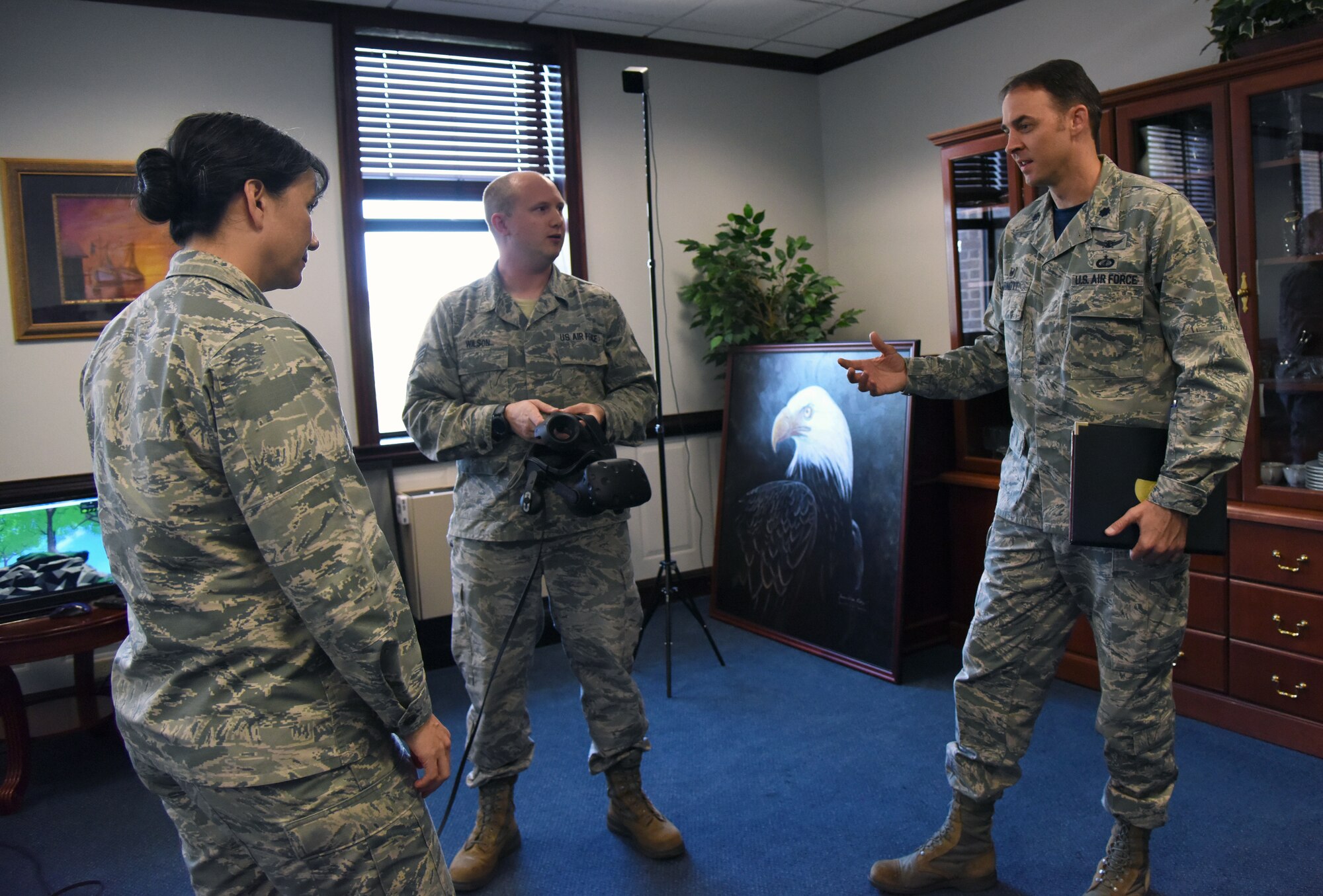 U.S. Air Force Lt. Col. Stephen Arnott, 81st Training Support Squadron commander, and Staff Sgt. Chris Wilson, 81st TRSS instructional developer, explain the benefits of using virtual reality for training purposes to Col. Debra Lovette, 81st Training Wing commander,  in the 81st TRW headquarters building at Keesler Air Force Base, Mississippi, May 4, 2018. The 81st Training Group has implemented augmented and virtual reality into training, such as airfield, weather and air traffic control training. (U.S. Air Force photo by Kemberly Groue)