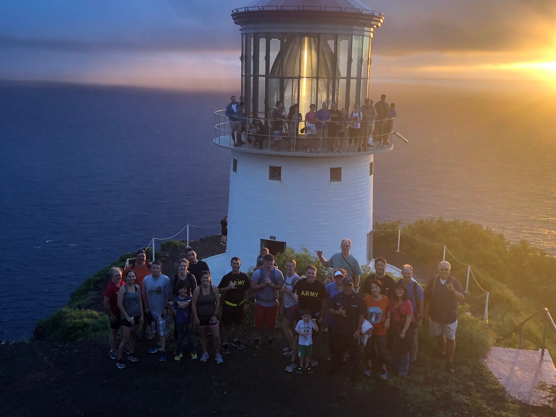 The Honolulu District U.S. Army Corps of Engineers Commander, Lt. Col. James D. Hoyman and Deputy Commander Maj. Thomas E. Piazze led about 50 Corps staff and family members for the sunrise hike April 6, 2018 celebrating the Districts 113th Birthday. The significance of Makapu'u Lighthouse for the Districts Birthday dates back to 1905 when the Corp’s began their mission in Hawaii and the Pacific. The Districts first commander Lt. Col. John Slattery was charged by Congress to constructions lighthouses for navigation and draw up plans for Makapu’u Lighthouse. In August 1906 Slattery designed a short tower keeping the light as low as possible but high enough the wind couldn’t blow pebbles into the lantern room glass. This first-ever 12-ton lens produced a fixed white light while a set of copper panels revolving on a track between the light source and lens produced a distinct flash.