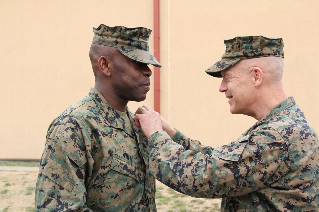 U.S. MARINE CORPS BASE, CAMP MUJUK – Maj. Gen. Patrick J. Hermesmann (RIGHT), commander of U.S. Marine Corps Forces Korea, pins Master Sgt. Olatokunbo A. White, MARFORK communications chief, to his current rank during his promotion and reenlistment ceremony here, May 1.  White, from Norfolk, Va., has served at Expeditionary Strike Group II, MARFORCOM, and MARFORK once before now. (Official U.S. Marine corps photo by Sgt. Nathaniel Hanscom/Released)
