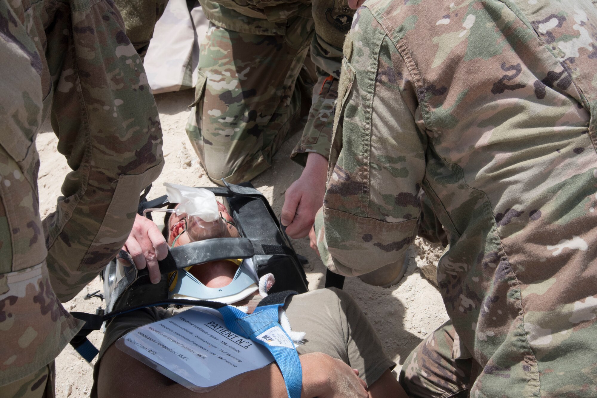 A role player simulating an injured pilot is loaded onto a stretcher during a joint agency exercise here, May 2. (U.S. Air National Guard photo by Staff Sgt. Erica Rodriguez)