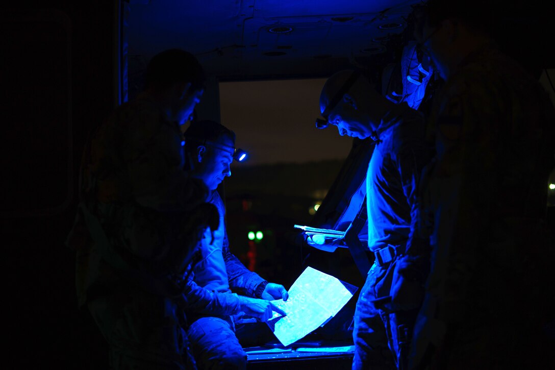 Army pilots and crew chiefs conduct preflight mission brief.