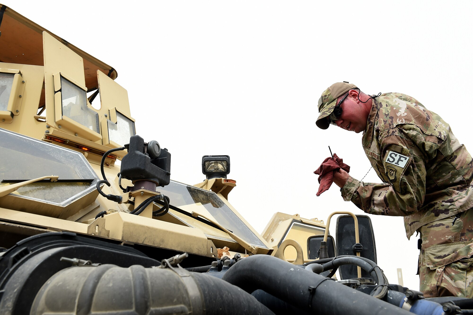 Staff Sgt. Nathan Wolf, 407th Expeditionary Security Forces Squadron craftsman, checks the oil level on a Mine Resistant Ambush Protected All-Terrain Vehicle.