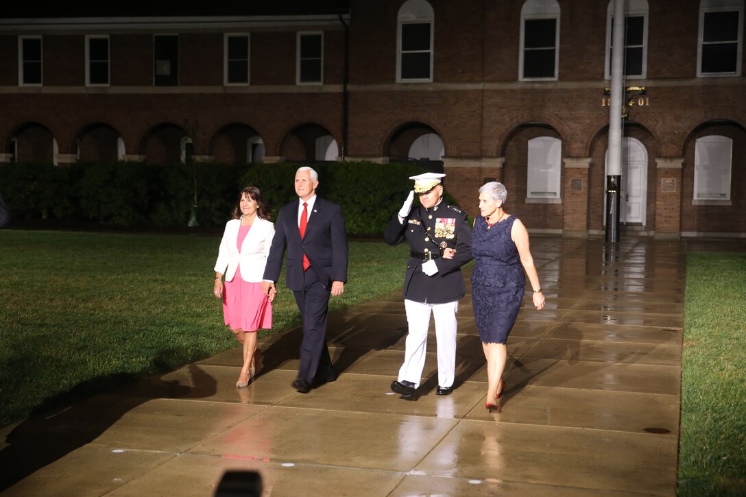 U.S. Vice President Mike Pence and his wife Second Lady Karen Pence,  and Commandant of the Marine Corps Gen. Robert B. Neller and his wife D’Arcy Neller walk to their seats following their formal introductions during the Friday Evening Parade at Marine Barracks Washington D.C.