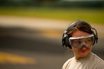 Senior Airman Michelle Reidel, an Air Transportation specialist assigned to the 30th Aerial Port Squadron, Air Reserve Station, Niagara Falls, N.Y., wears her hearing and eye protection on the flight line before an aircraft unloading during Exercise Global Medic, Fort McCoy, Wis., July 20, 2013.