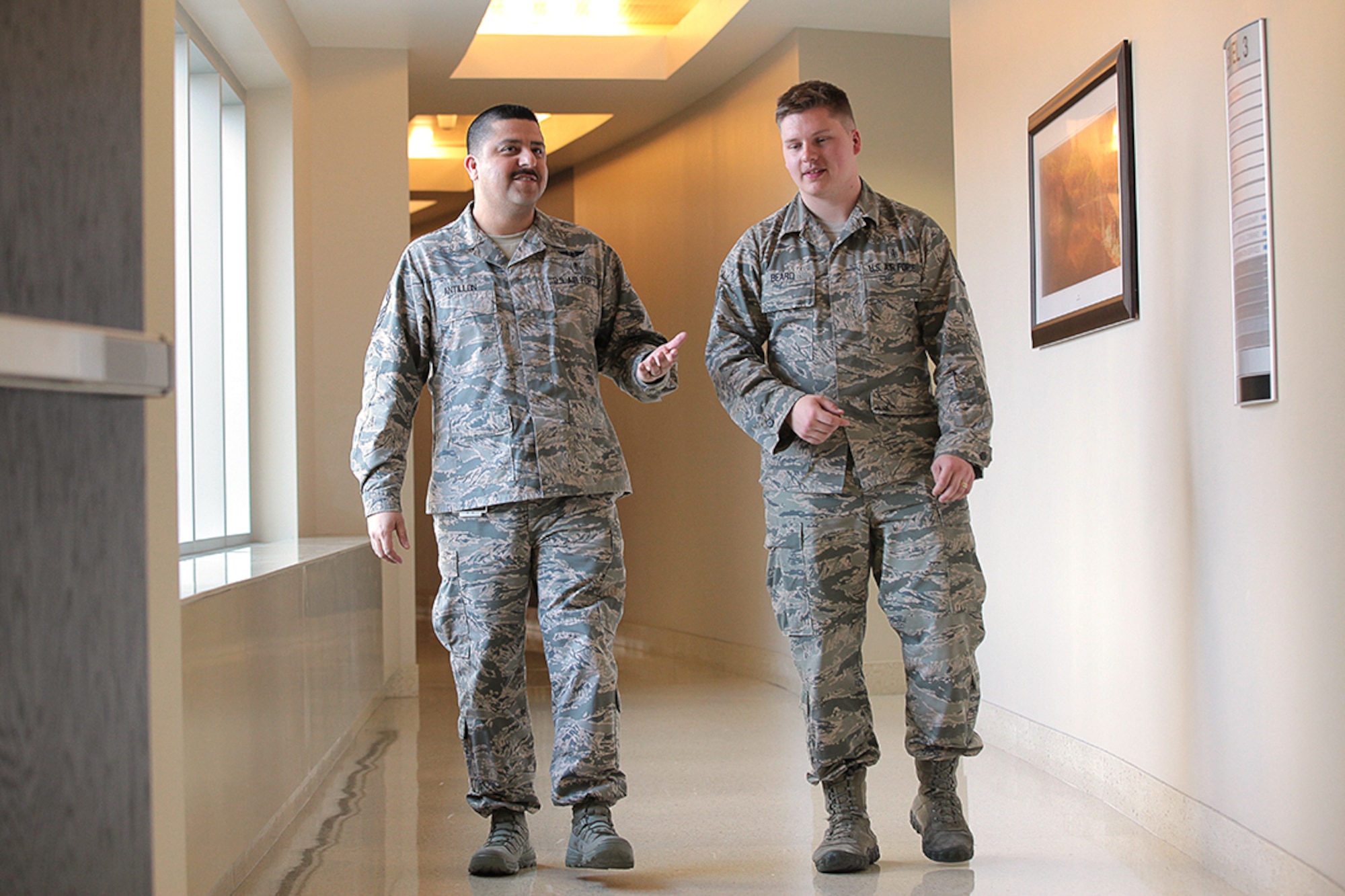 U.S. Air Force Senior Master Sgt. Jesus Antillon and Staff Sgt. Joseph Beard, medical technicians with the 11th Medical Group at Joint Base Andrews, Md., discuss patient care, April 5, 2018. (Defense Health Agency photo by Jamie Chirinos)