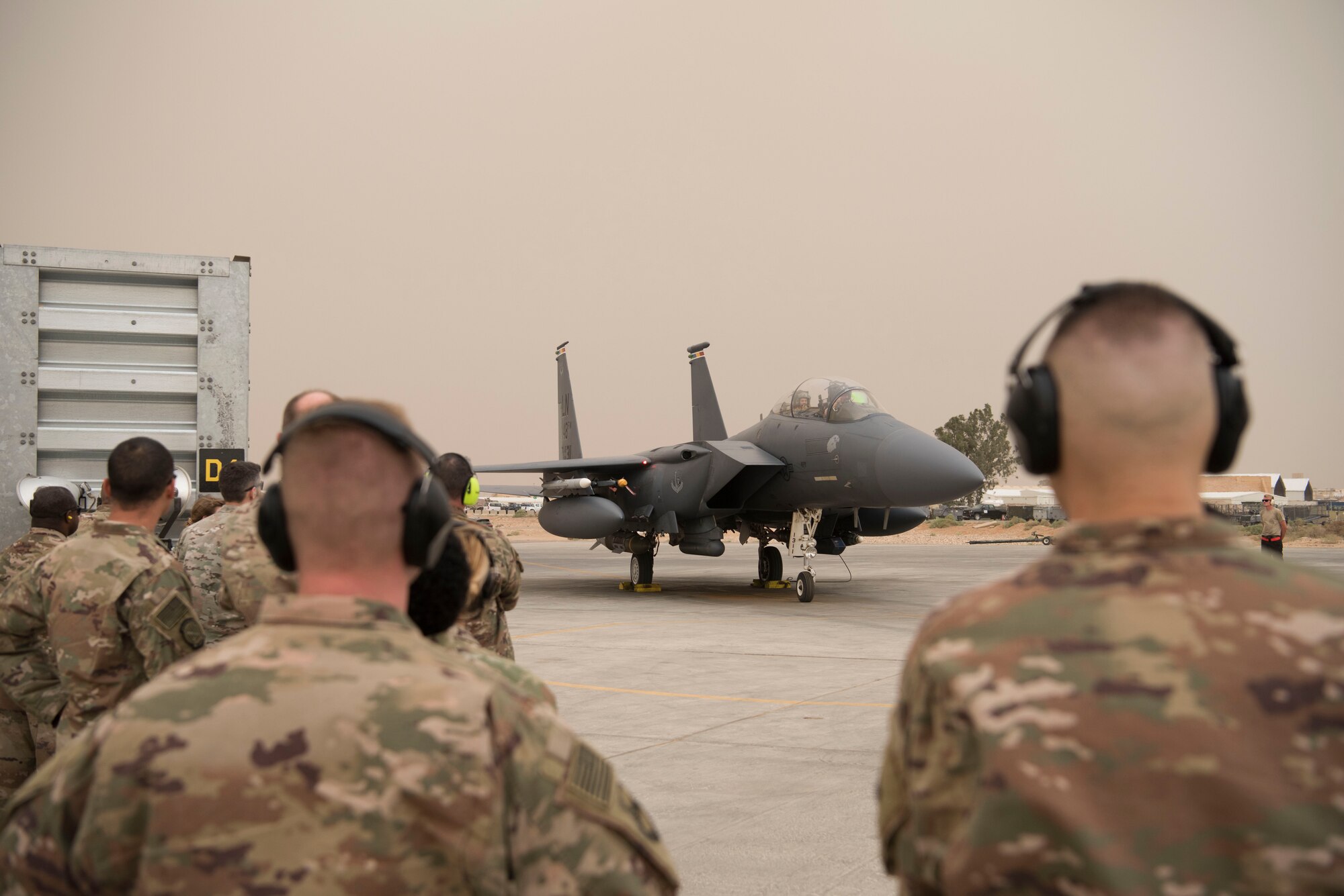 Airmen with the 332nd Air Expeditionary Wing wait for Col. Shane Steinke, 332nd AEW vice commander, to disembark to congratulate him after completing his final flight May 7, 2018, at an undisclosed location in Southwest Asia