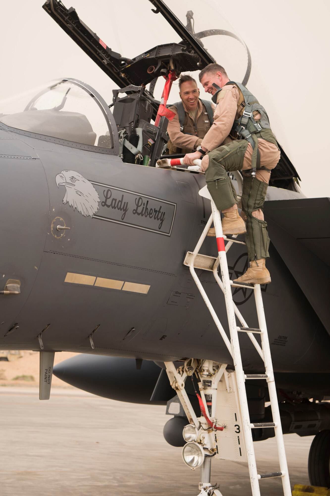 Brig. Gen. Kyle Robinson, 332nd Air Expeditionary Wing commander, disembarks from an F-15E Strike Eagle with Col. Shane Steinke, 332nd AEW vice commander, May 7, 2018, at an undisclosed location in Southwest Asia.