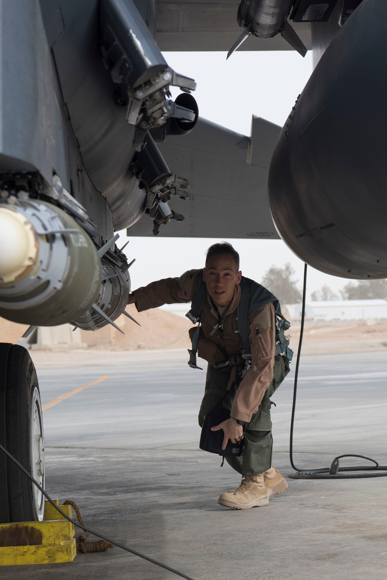 Col. Shane Steinke, 332nd Air Expeditionary Wing vice commander, performs pre-checks prior to flying May 7, 2018, at an undisclosed location in Southwest Asia.